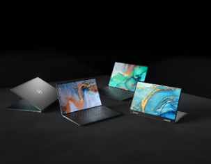 Three laptops on a dark surface